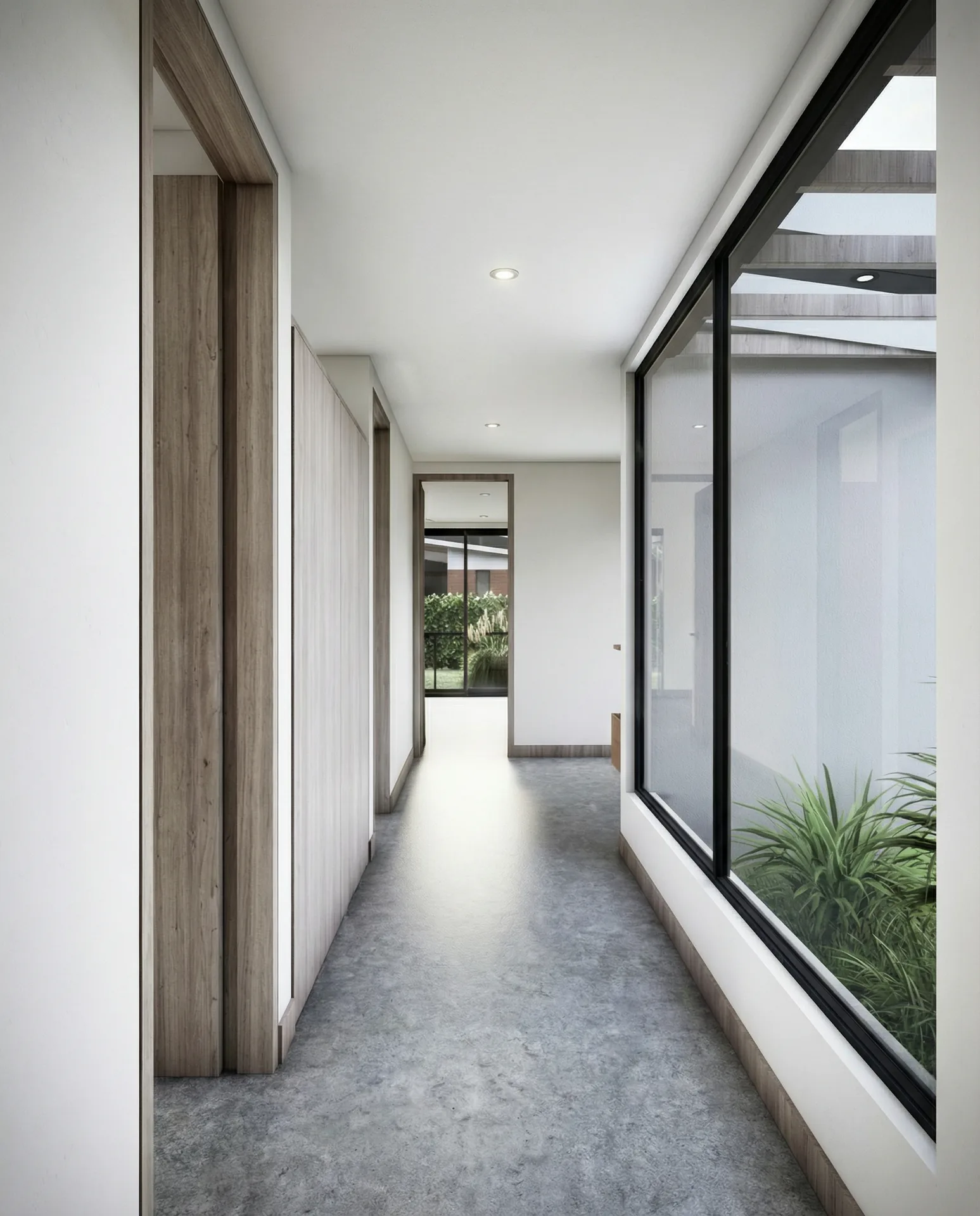 Pasillo interior iluminado por ventanales con vista al jardin